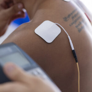 Image of an electrode stuck to a man's shoulder.