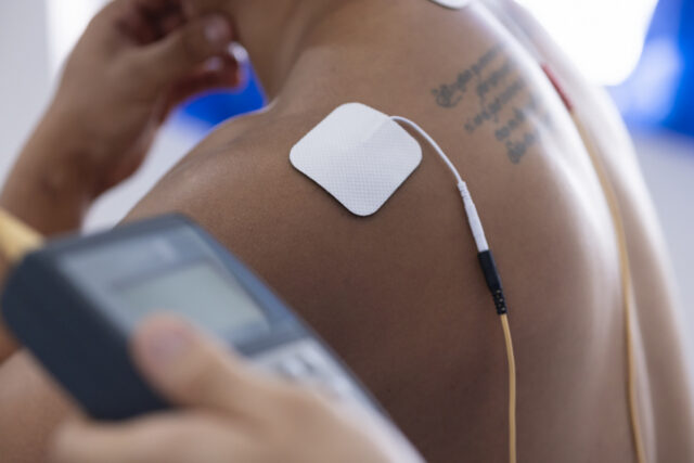 Image of an electrode stuck to a man's shoulder.