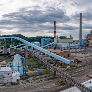 Image of a coal-fired power plant, showing lots of conveyor belts and a few smokestacks.