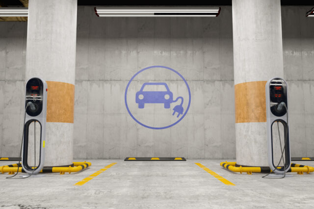 Electric Vehicle Charging Station in Underground Parking Lot. 3D Render