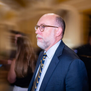 Image of a bald man with a beard and glasses.