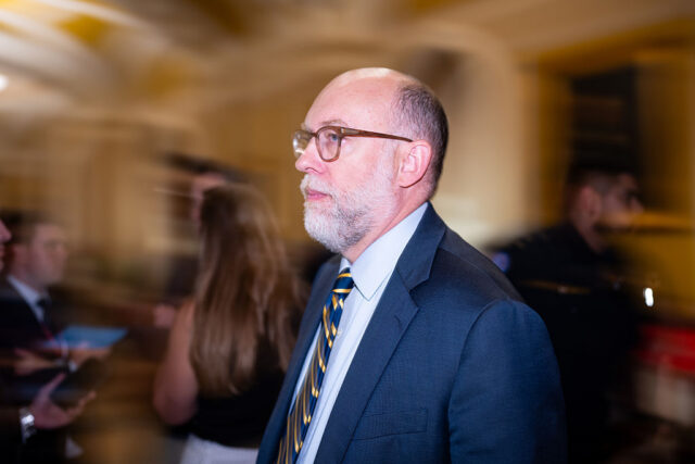 Image of a bald man with a beard and glasses.