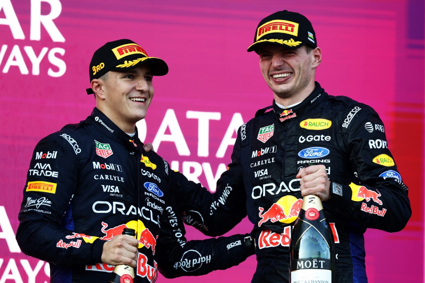 BAKU, AZERBAIJAN - SEPTEMBER 26: Second placed Max Verstappen of the Netherlands and Oracle Red Bull Racing and Third placed Isack Hadjar of France and Oracle Red Bull Racing celebrate on the podium during the F1 Grand Prix of Azerbaijan at Baku City Circuit on September 26, 2026 in Baku, Azerbaijan. (Photo by Mark Thompson/Getty Images)