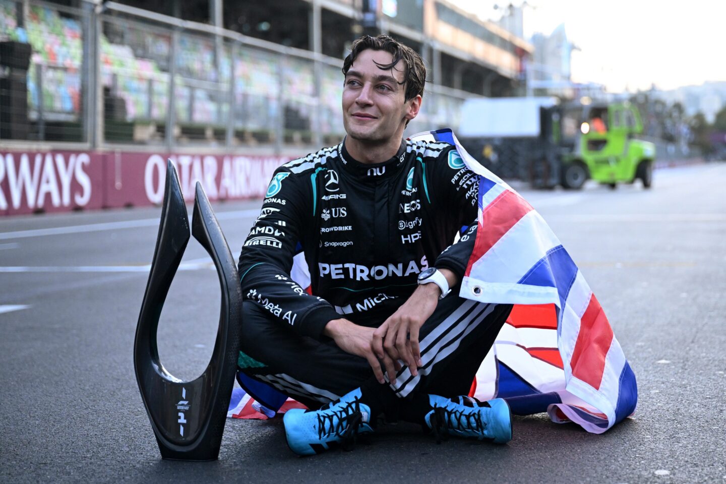  Race winner George Russell of Great Britain and Mercedes AMG Petronas F1 Team celebrates with his trophy and national flag during the F1 Grand Prix of Azerbaijan at Baku City Circuit on September 26, 2026 in Baku, Azerbaijan. (Photo by Mark Sutton - Formula 1/Formula 1 via Getty Images)