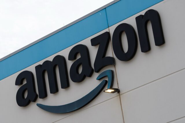An Amazon company logo affixed to the exterior of a building.