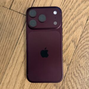 An iPhone on a wood surface