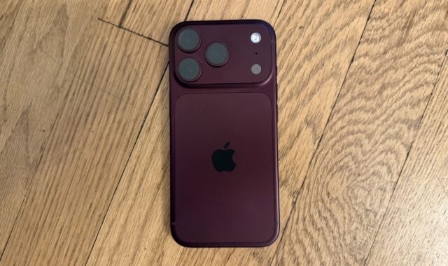 An iPhone on a wood surface