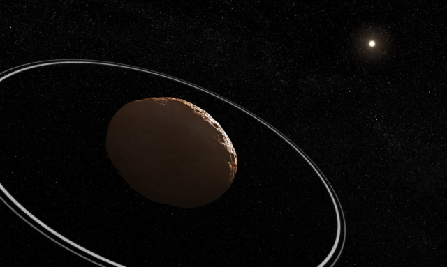 Artist's conception of a lumpy, reddish body, dimly lit by the Sun, with two thin rings surrounding it.
