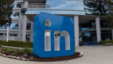 A large sculpture with LinkedIn's logo is displayed outside the company's headquarters building.