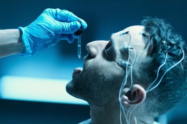 shot of a young man with EEG on forehead being dosed via a dropper