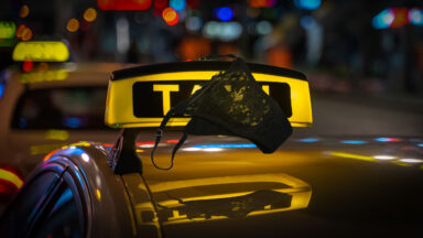 women's underwear on top of an illuminated taxi sign