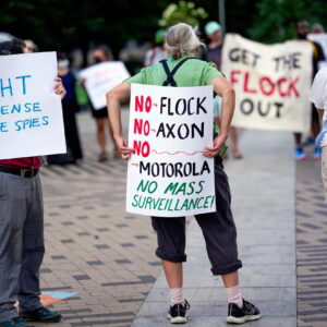 Protesters holding anti-Flock signs