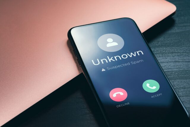 Incoming call on a smartphone screen labeled as "Unknown, suspected spam"