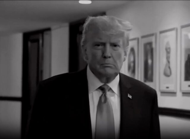 Trump walking down a hallway in a screenshot from a TV commercial.