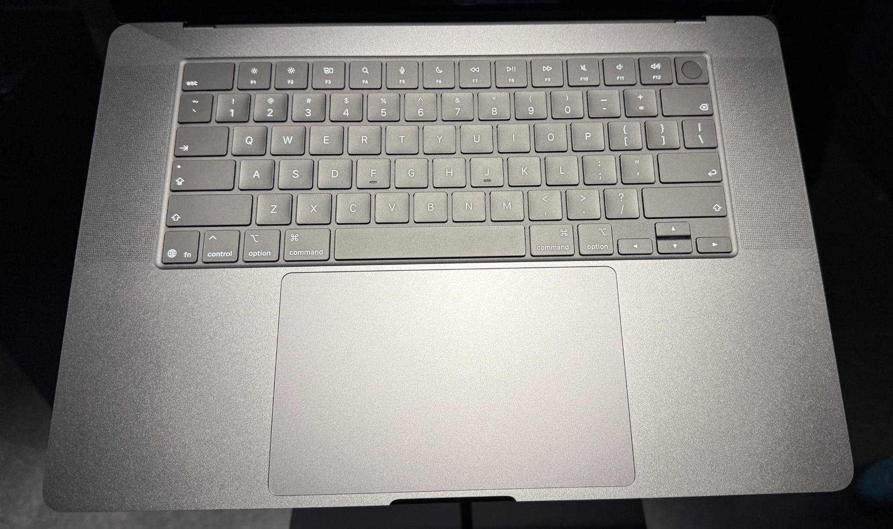 A standard Apple laptop keyboard and trackpad