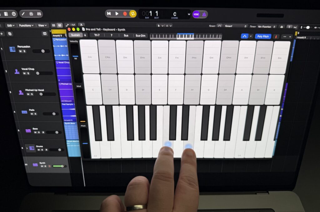 Fingers pressing virtual keyboard keys on the screen