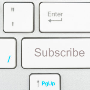 A picture of a white keyboard zoomed in on a key that says "Subscibe."