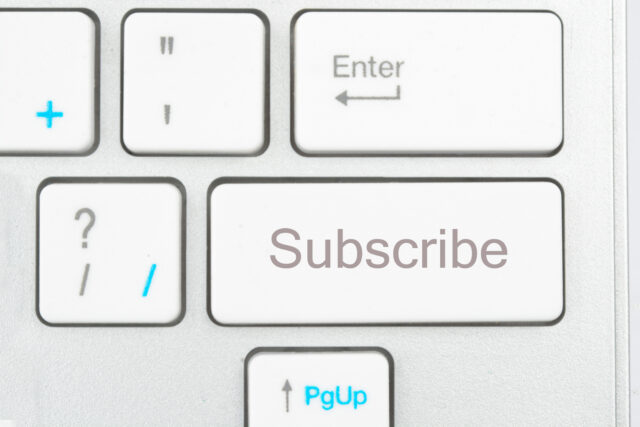 A picture of a white keyboard zoomed in on a key that says "Subscibe."