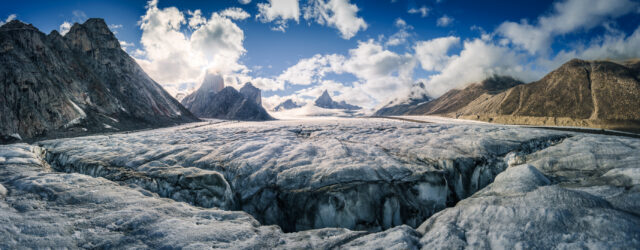 Image of sharp peaks sitting above a large glacier.