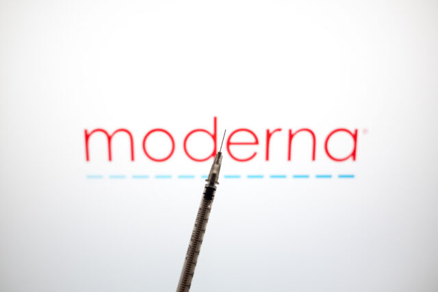 The Moderna logo with a vaccine syringe in front.