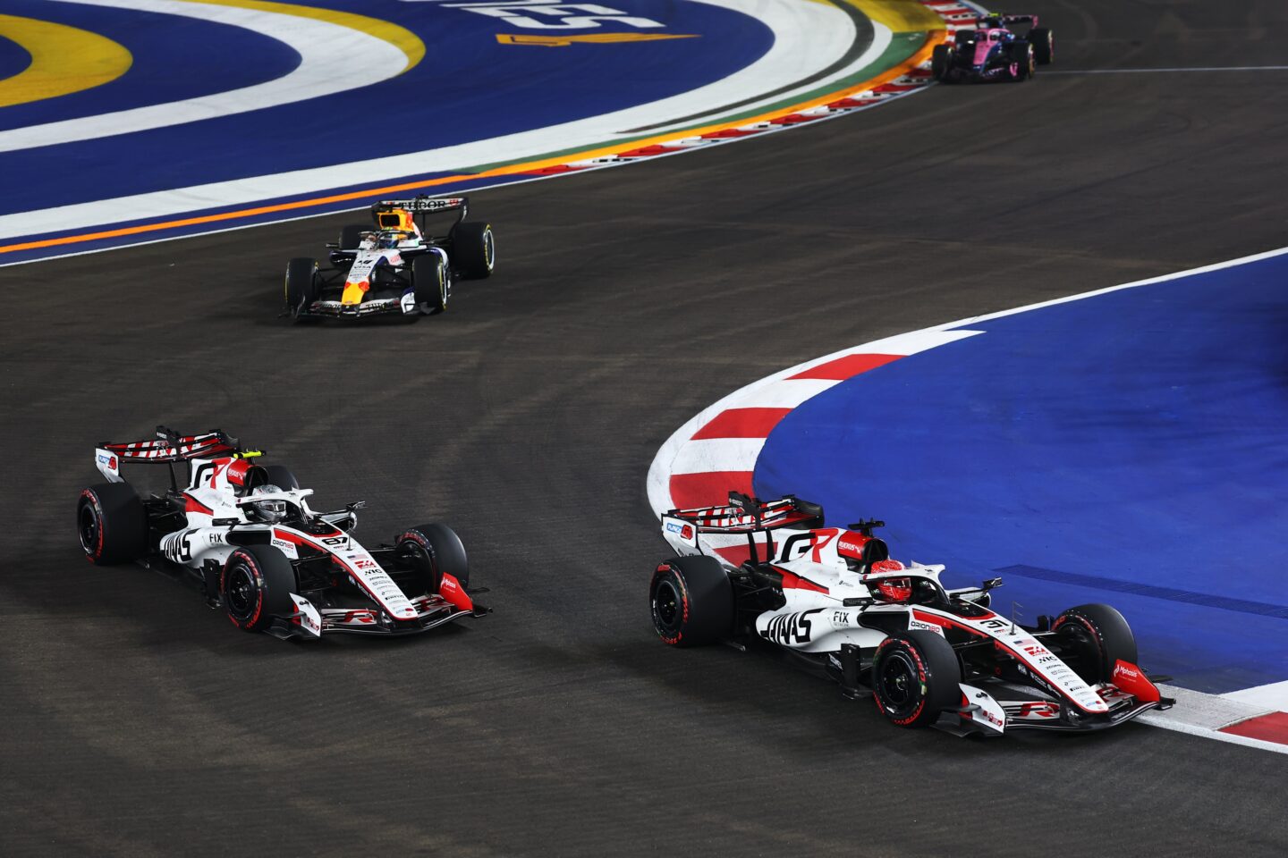  Esteban Ocon of France driving the (31) Haas F1 VF-26 Ferrari and Oliver Bearman of Great Britain driving the (87) Haas F1 VF-26 Ferrari battle for track position during the F1 Grand Prix of Singapore at Marina Bay Street Circuit on October 11, 2026 in Singapore, Singapore. (Photo by Mark Thompson/Getty Images)