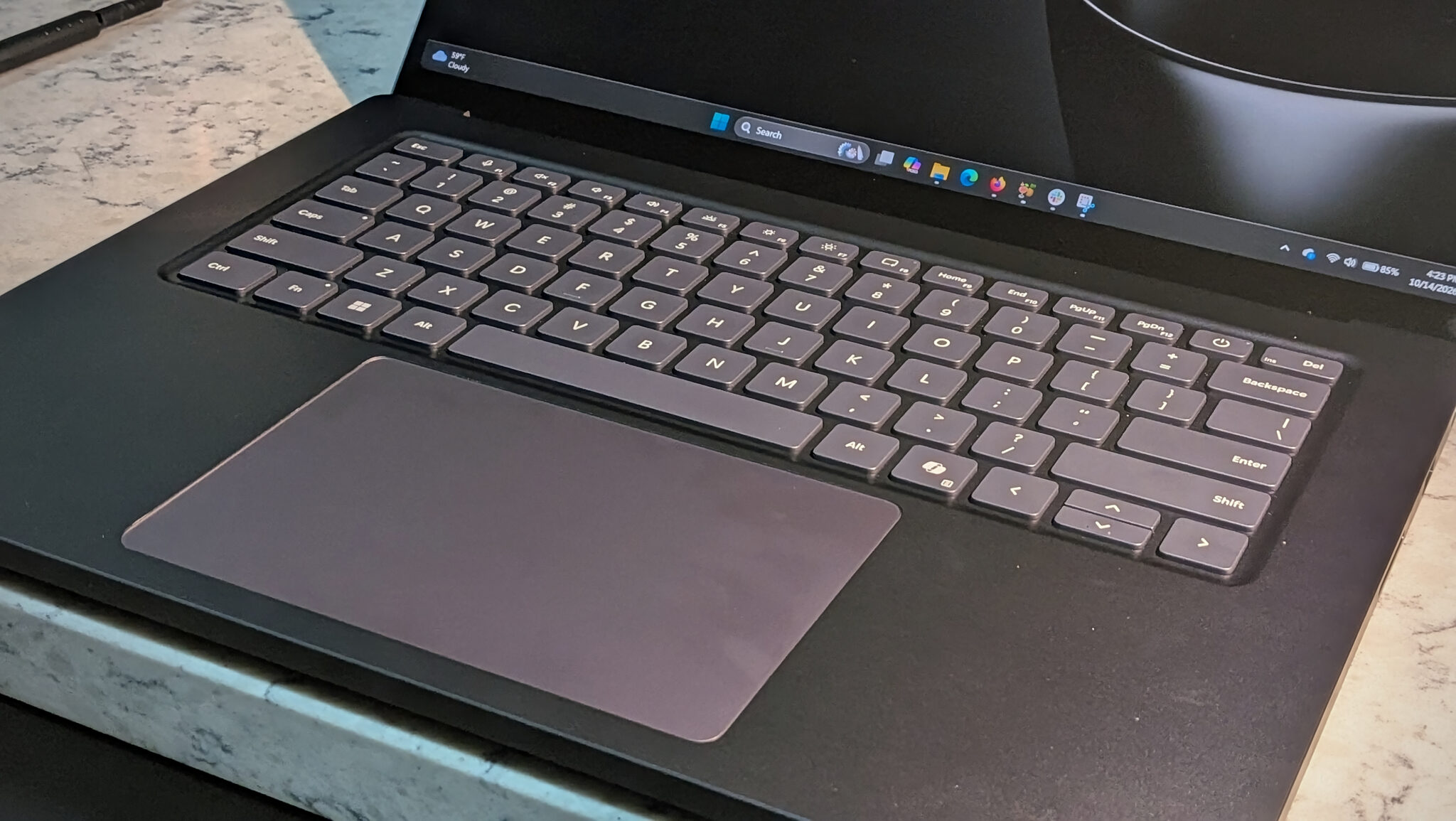 A close up photo of the keyboard and trackpad on the Surface Ultra