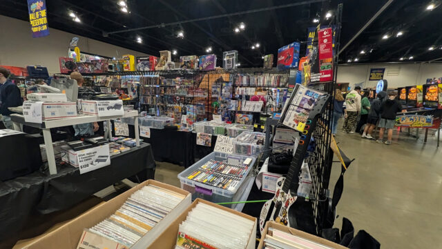 A vendor sells classic video games at a Pinball Expo booth.