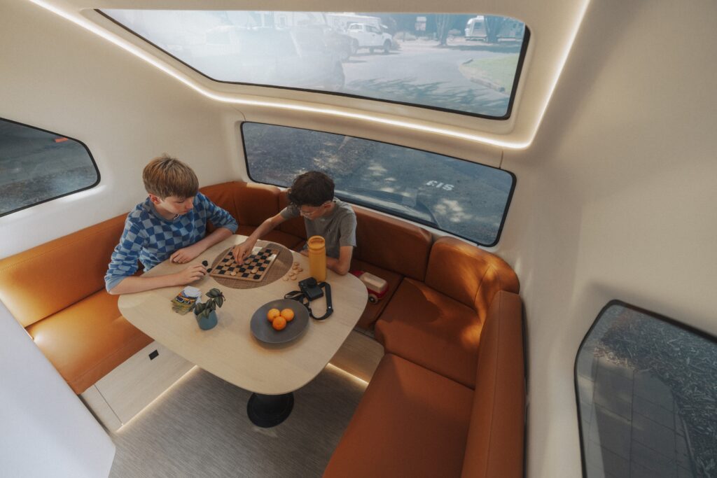 Children play chess inside a trailer