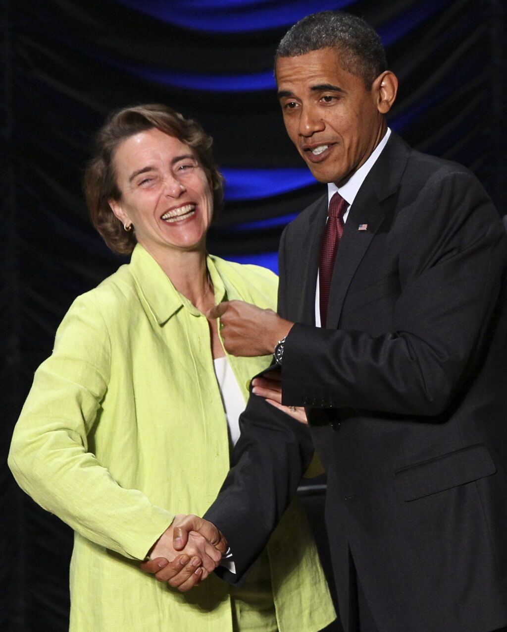President Barack Obama and Sen. Blanche Lincoln smile and shake hands.