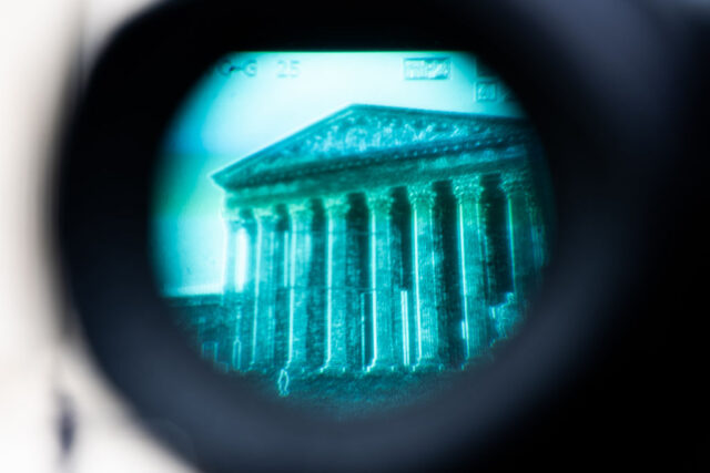 A court building seen through a camera viewfinder