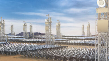 Image of a series of towers, each with a square patch of mirrors in front of it.