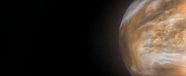 Image of a yellow brown planet on the right of a wide field view.