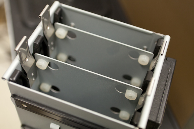 Removable drive cage with removable hard drive sleds. Notice the thick silicone grommets and well-fitted plastic slides for vibration control and isolation, rounded edges for rigidity and safety. (Antec P180)