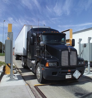 Truck weigh-and-inspection station with radiation portal monitor.