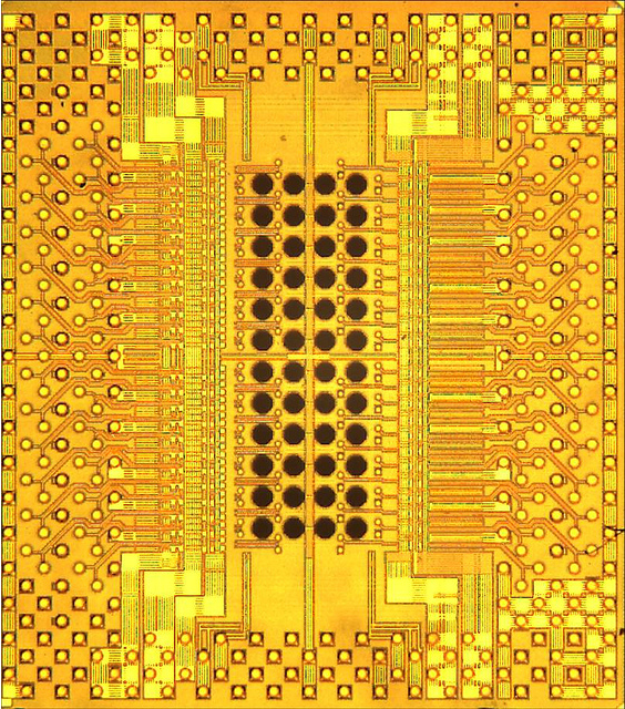 Photomicrograph of Holey Optochip, with 48 holes allowing optical access through the back of the chip to receiver and transmitter channels.