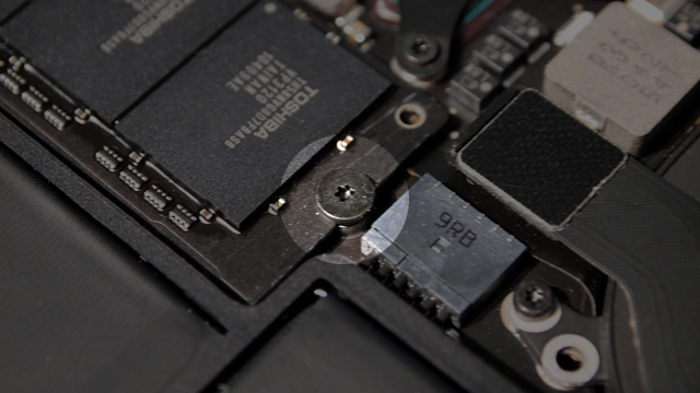 The Torx T5 screw that holds the MacBook Air's SSD in place (highlighted) has a large, flat head.