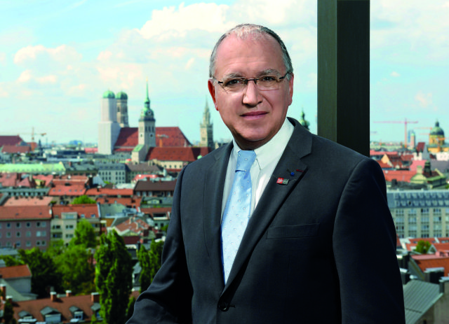EPO President Benoît Battistelli in his office with views of Munich in the background.