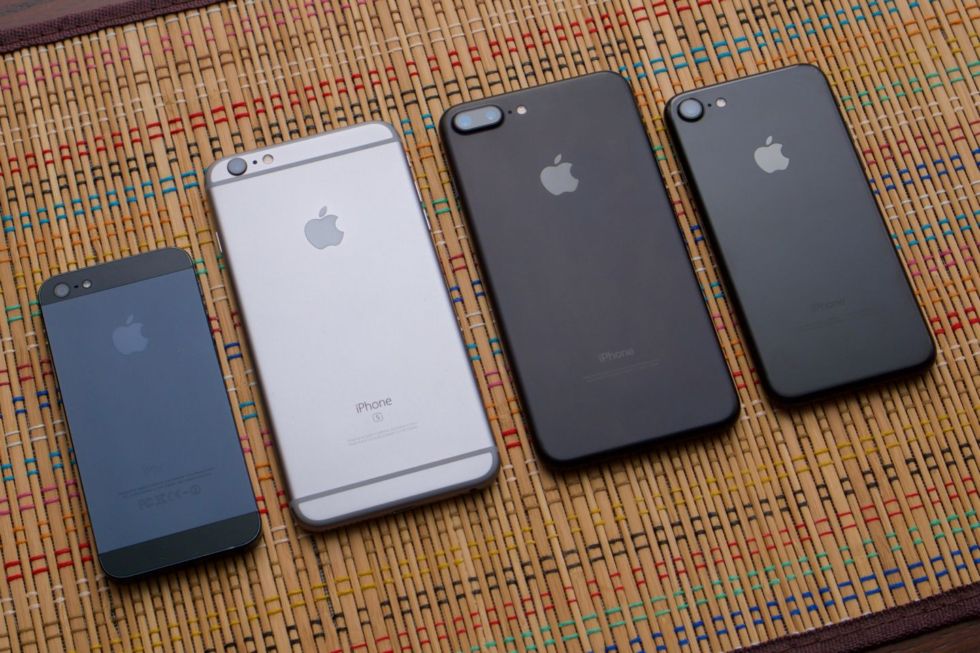 From left to right: black iPhone 5, space grey 6S Plus, black 7 Plus, jet black 7.