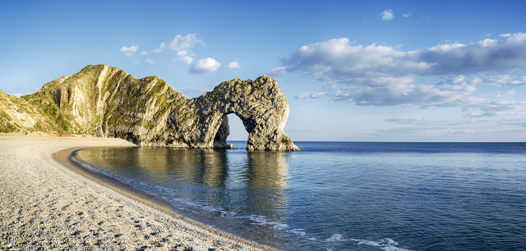 Durdle Door on Dorset's Jurassic Coast is the result of coastal erosion weakening fractures in the limestone cliffs.